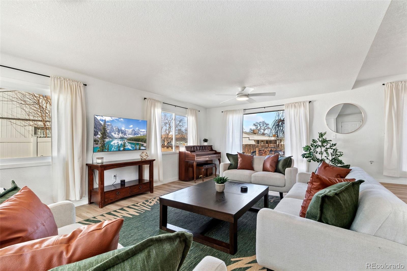 5533 Raritan Way Denver, CO 80221 - Photo 2 of 22 a living room with furniture and a flat screen tv