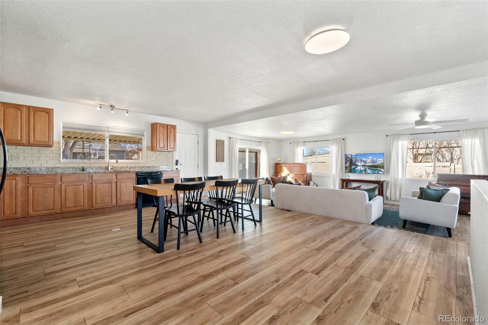 5533 Raritan Way Denver, CO 80221 - Photo 4 of 22 a view of a dining room with furniture and wooden floor