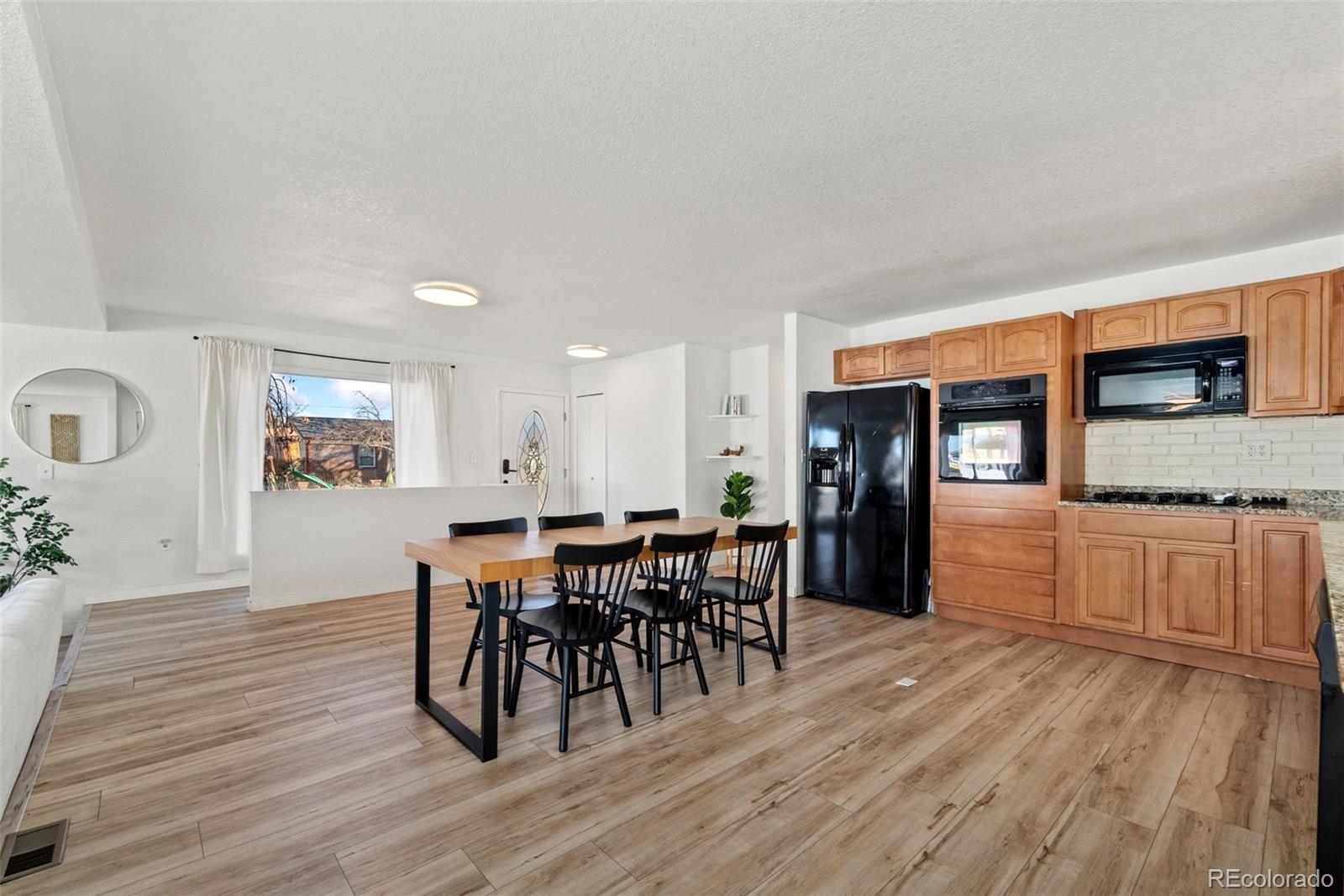 5533 Raritan Way Denver, CO 80221 - Photo 5 of 22 a view of a dining room with furniture and wooden floor