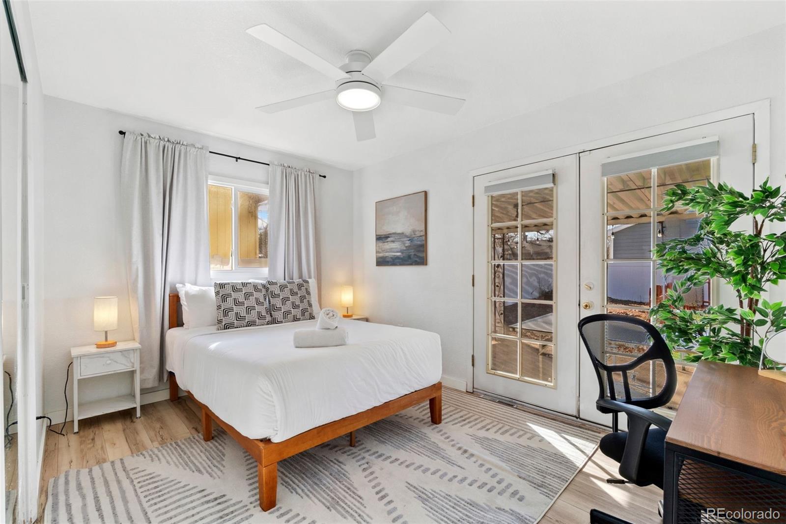 5533 Raritan Way Denver, CO 80221 - Photo 6 of 22 a bedroom with a bed and a potted plant on the dresser