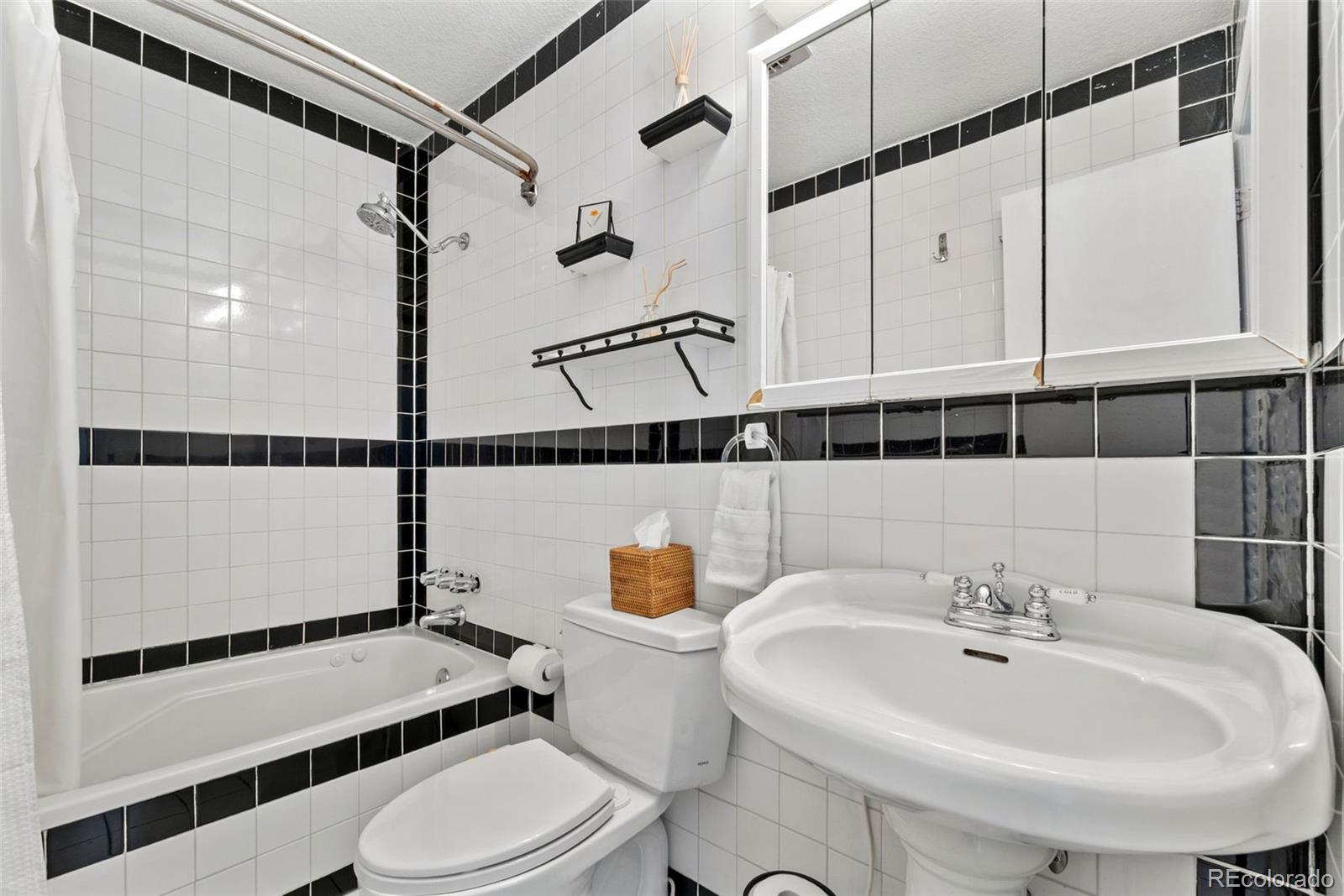 5533 Raritan Way Denver, CO 80221 - Photo 7 of 22 a bathroom with a sink a toilet and shower