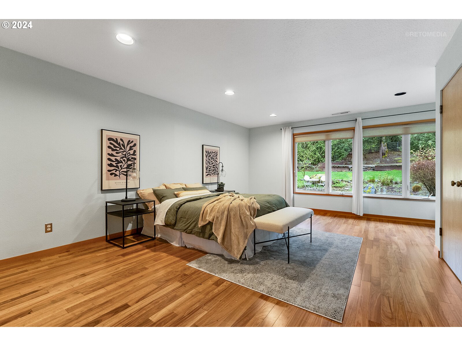 3730 Southwest Shattuck Road Portland, OR 97221 - Photo 14 of 44 a bedroom with a bed and wooden floor