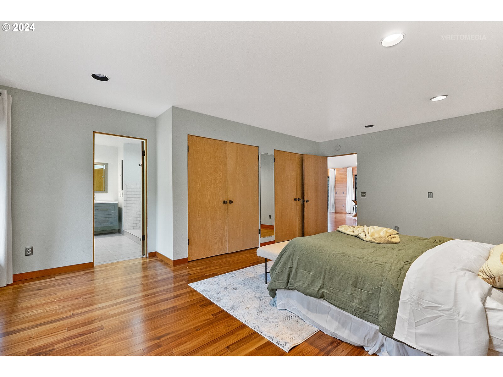 3730 Southwest Shattuck Road Portland, OR 97221 - Photo 15 of 44 a bedroom with a bed and wooden floor