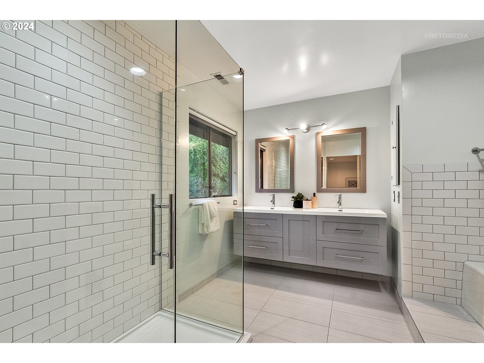 3730 Southwest Shattuck Road Portland, OR 97221 - Photo 16 of 44 a bathroom with a sink a mirror and shower