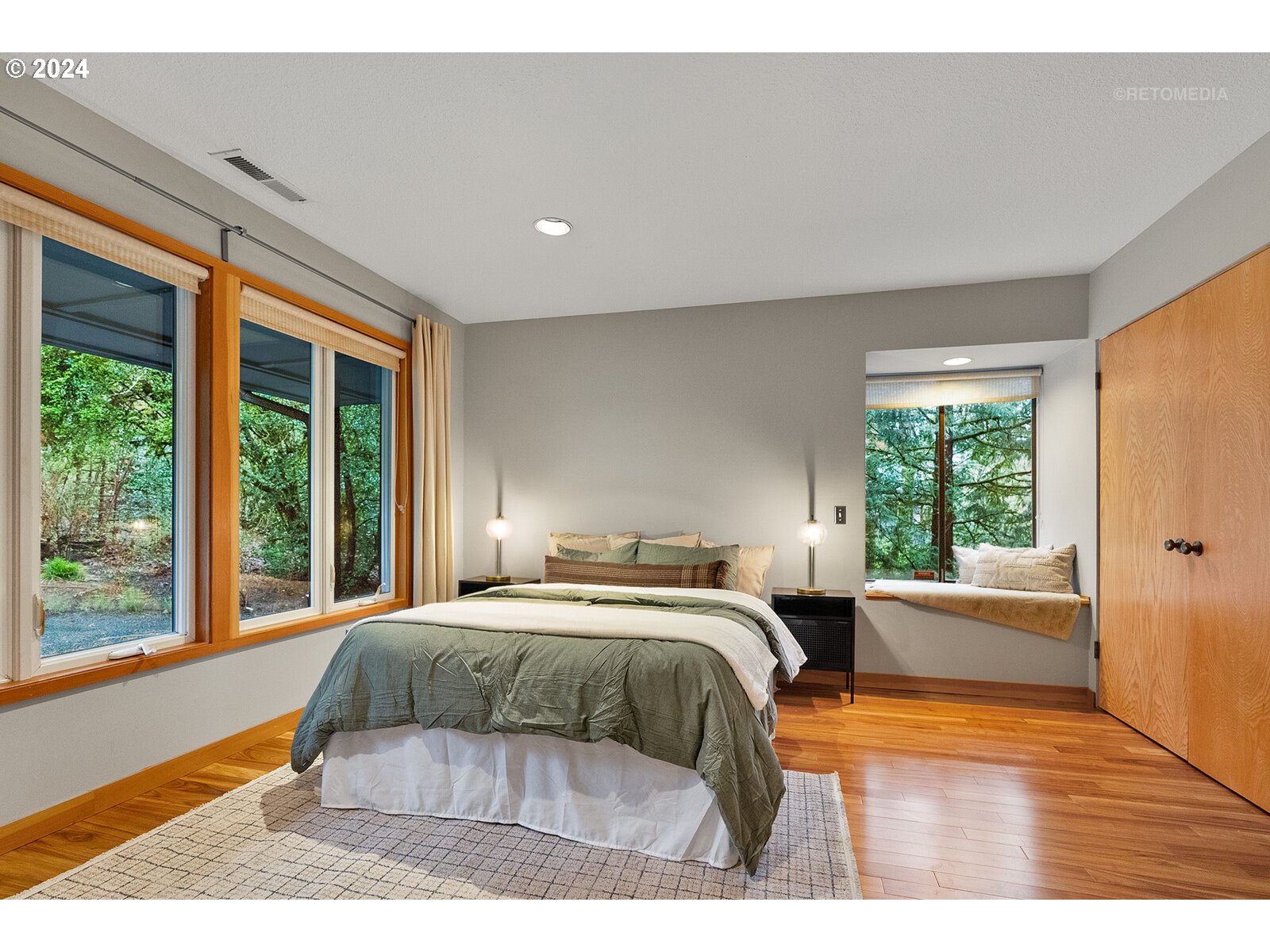 3730 Southwest Shattuck Road Portland, OR 97221 - Photo 18 of 44 a bedroom with a large bed and a large window