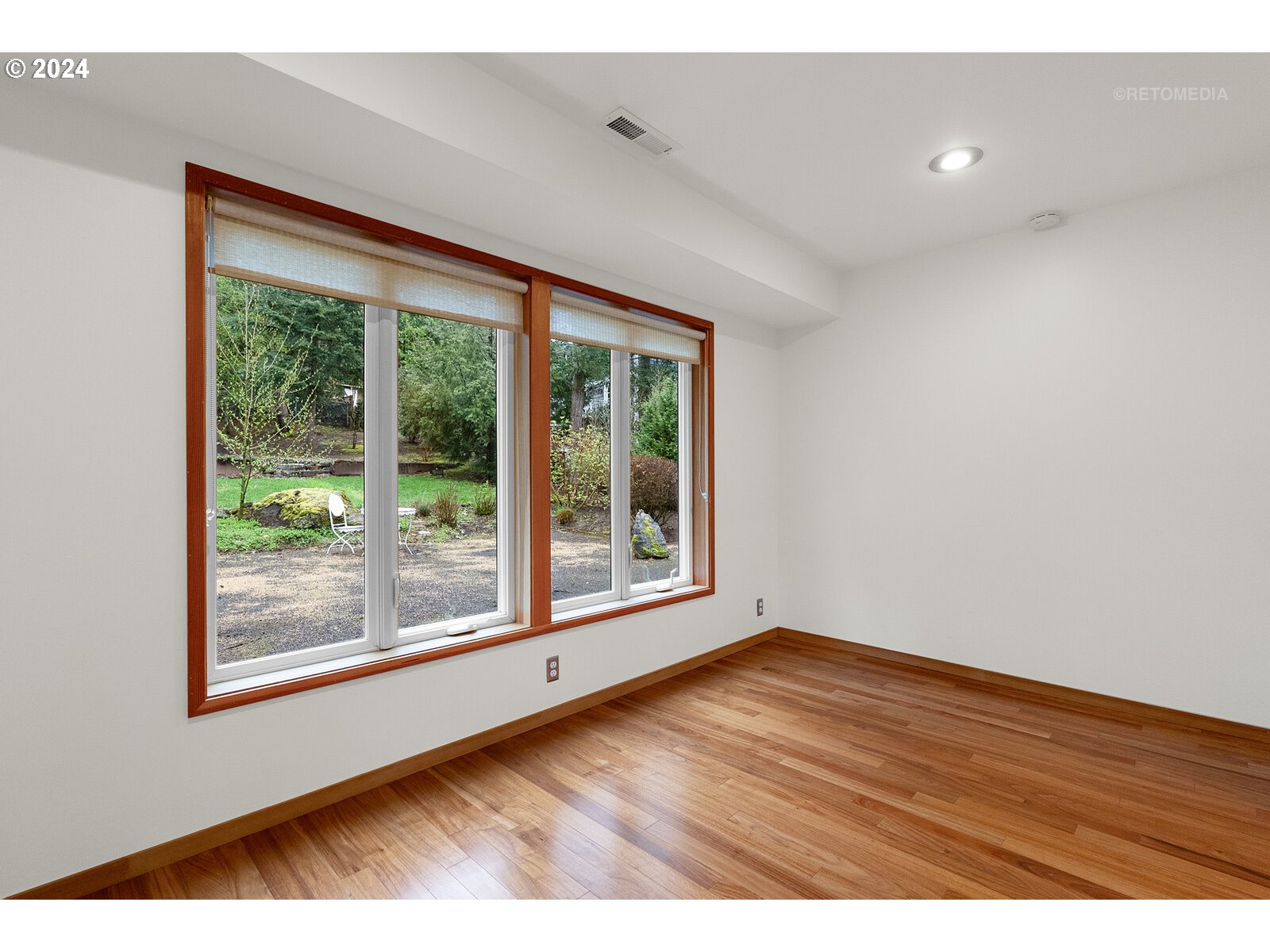 3730 Southwest Shattuck Road Portland, OR 97221 - Photo 22 of 44 a view of an empty room with wooden floor and a window