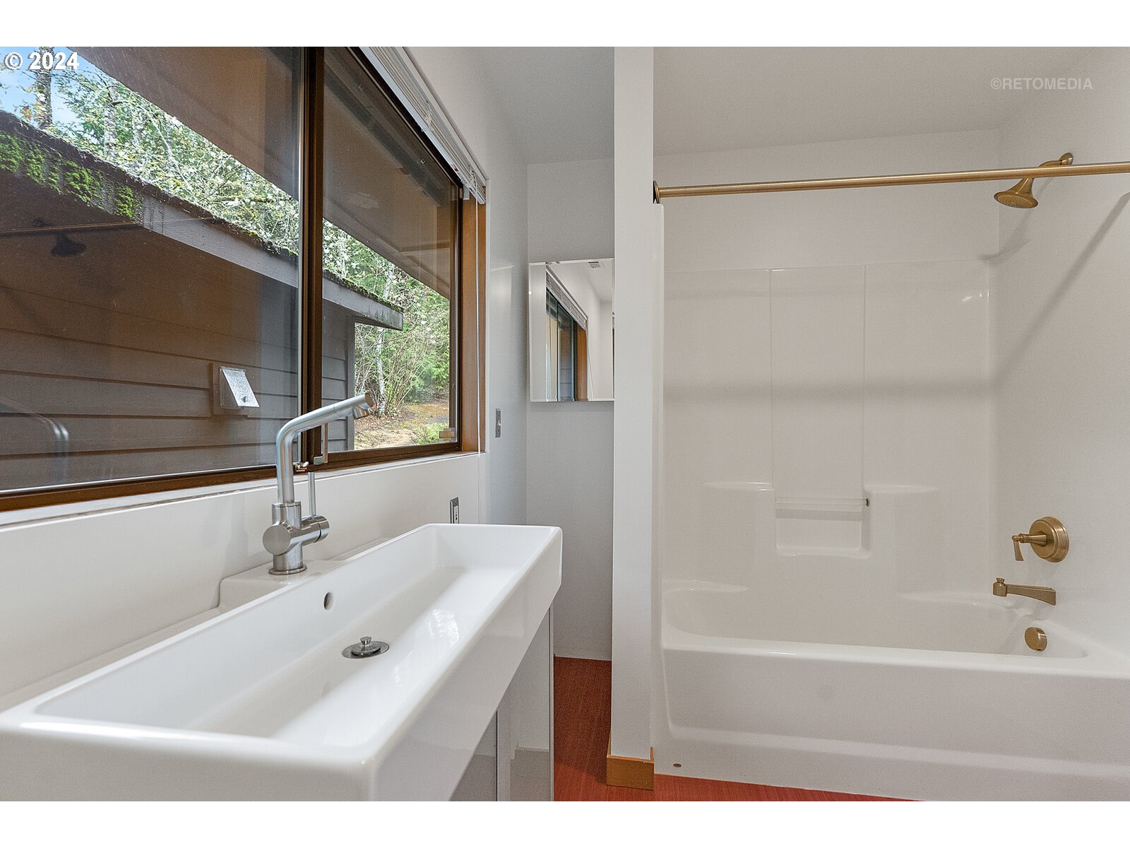 3730 Southwest Shattuck Road Portland, OR 97221 - Photo 23 of 44 a bathroom with a tub a sink and a window