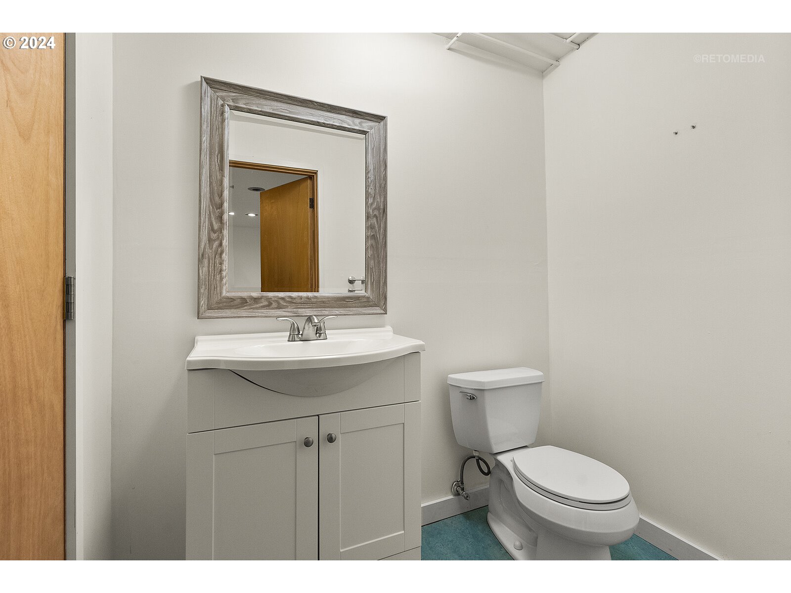 3730 Southwest Shattuck Road Portland, OR 97221 - Photo 26 of 44 a bathroom with a toilet a sink and mirror