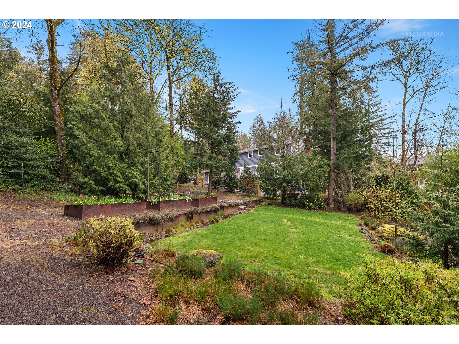3730 Southwest Shattuck Road Portland, OR 97221 - Photo 29 of 44 a view of a backyard with plants and lake