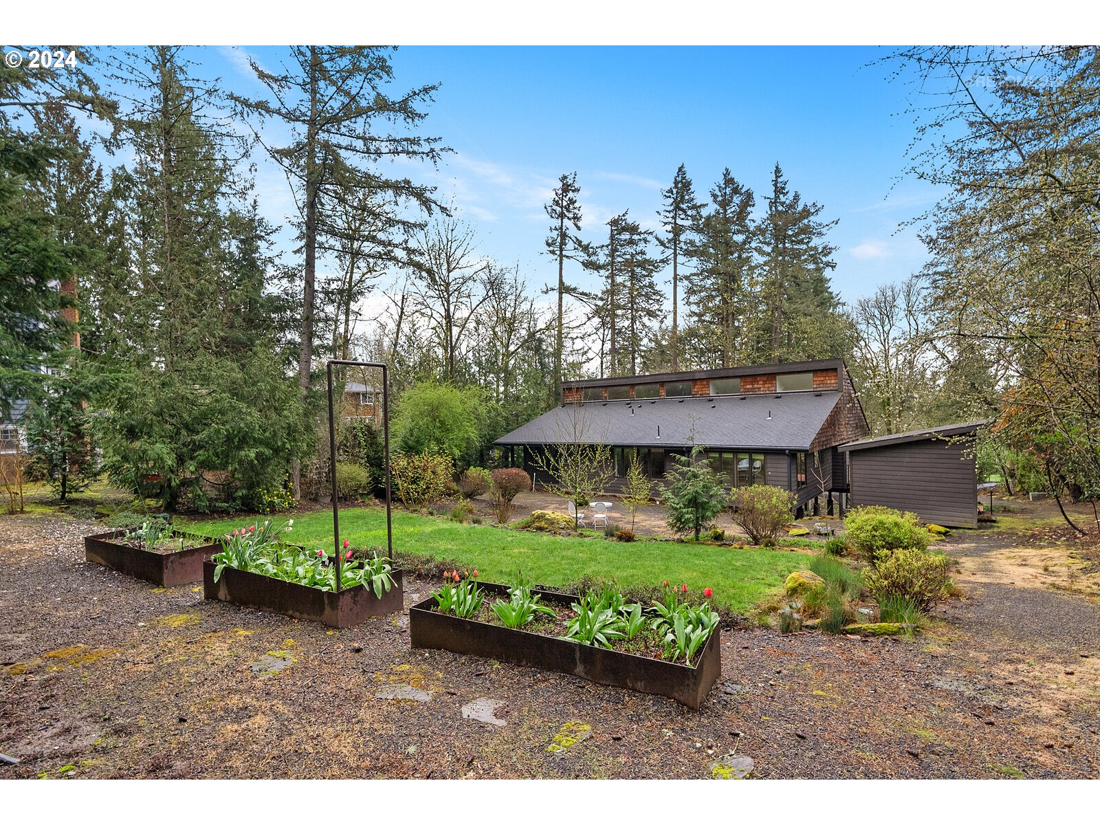 3730 Southwest Shattuck Road Portland, OR 97221 - Photo 30 of 44 a small garden in the middle of a forest