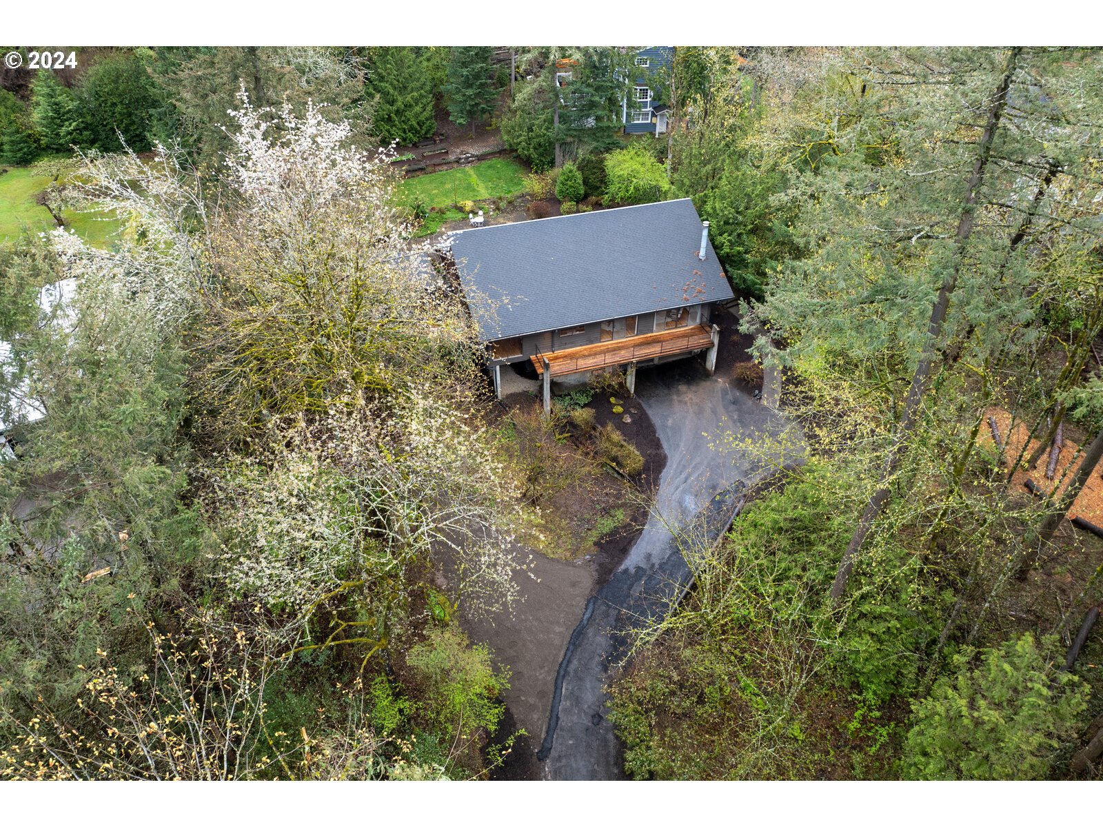 3730 Southwest Shattuck Road Portland, OR 97221 - Photo 34 of 44 a view of a backyard with table and chairs and wooden fence