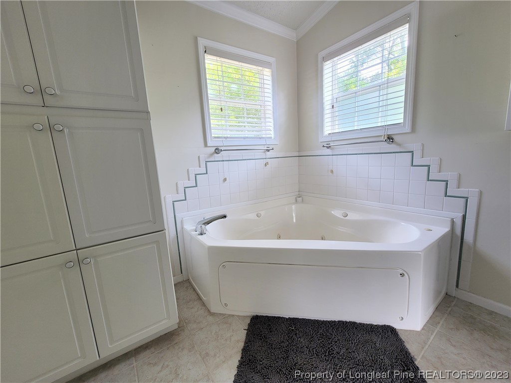 400 Ridge View Drive Cameron, NC 28326 - Photo 14 of 40 a white bath tub sitting in a bathroom next to a window