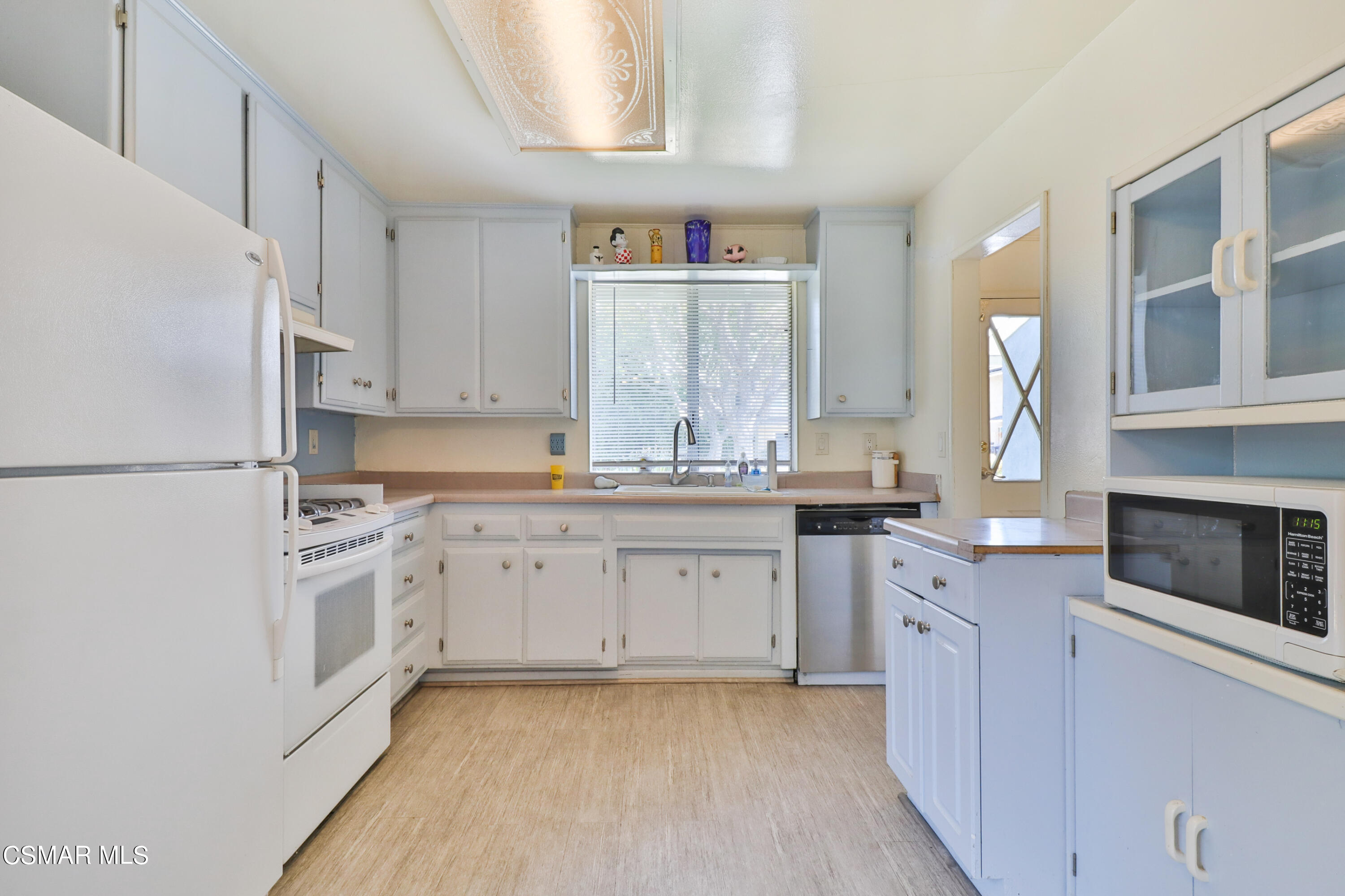 905 Appleton Road Simi Valley, CA 93065 - Photo 6 of 34 a kitchen with granite countertop white cabinets and white appliances