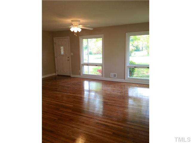 905 Powell Drive Raleigh, NC 27606 - Photo 4 of 11 Beautiful large living room with a wall of windows along the front and side for lots of natural light. Hardwood floors and storm doors.