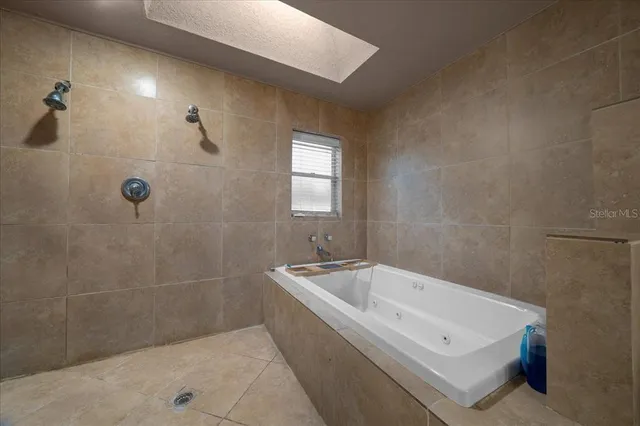a bathroom with a bathtub and shower