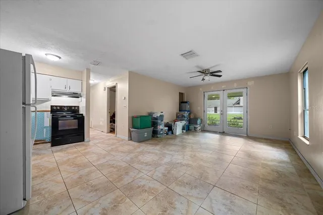 a view of a kitchen with a sink and furniture
