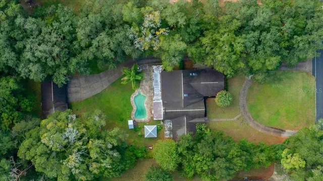 an aerial view of a house with a yard