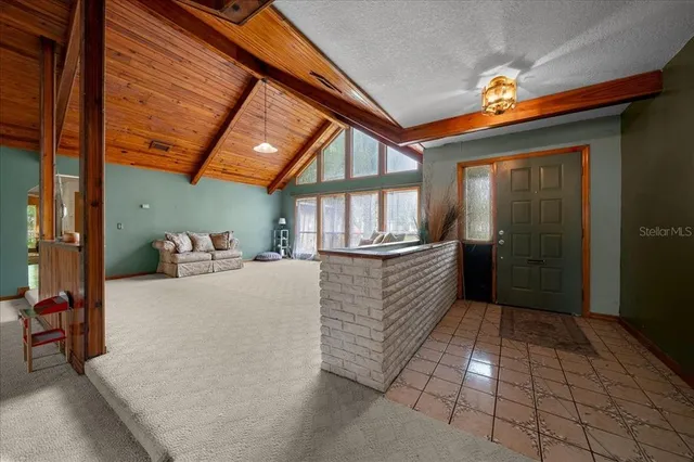 a large room with a large window and furniture