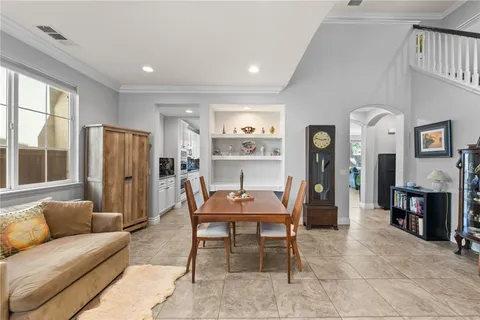 a kitchen with a dining table chairs and white appliances