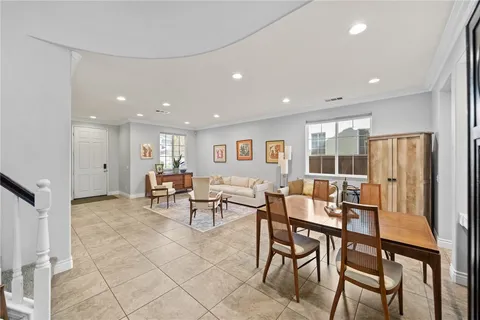 a kitchen with a refrigerator and white cabinets