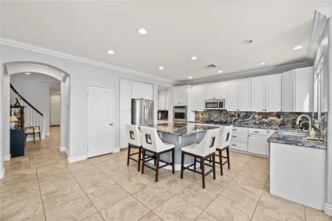 a bedroom with a bed and a flat tv screen on a dresser