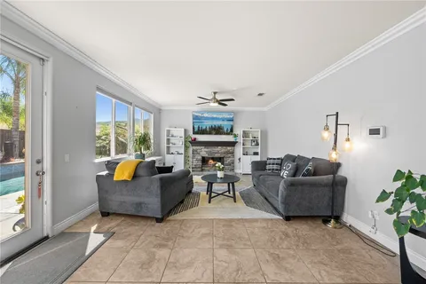 a living room with furniture ceiling fan and a window