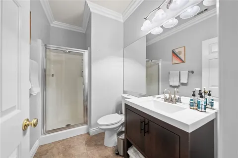 a bathroom with a granite countertop sink mirror and a shower