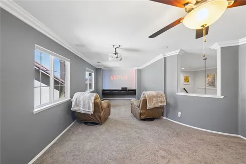 a spacious bedroom with a large bed and a chandelier