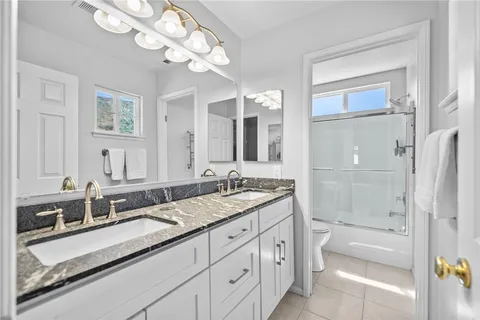 a en suite bathroom with a sink double vanity and a mirror