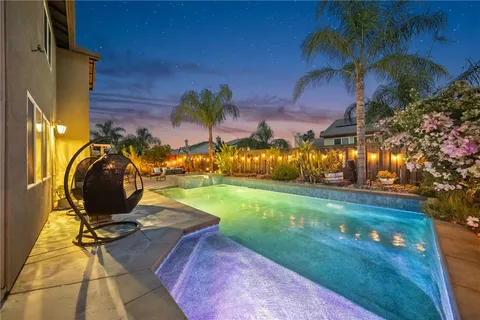 a view of a patio with couches table and chairs and potted plants