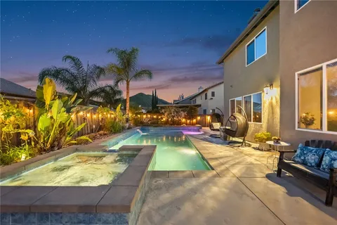 a view of a patio with couches table and chairs and potted plants