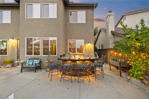 a living room with lots of furniture and a dining table with wooden floor