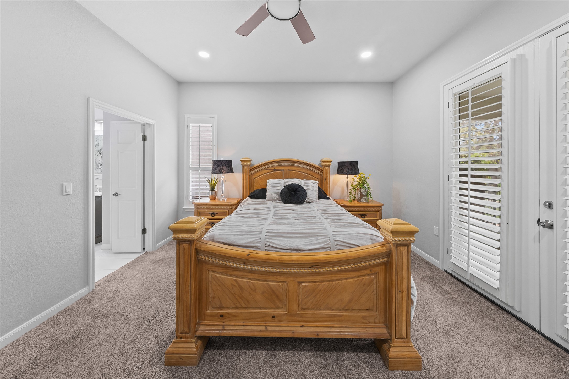 144 Stetson Trail Georgetown, TX 78633 - Photo 24 of 39 Primary bedroom featuring access to outside, carpet floors, and recessed lighting