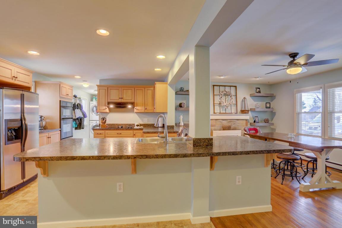 249 East Oregon Road Lititz, PA 17543 - Photo 5 of 30 a view of a kitchen with kitchen island a large counter top stainless steel appliances and cabinets