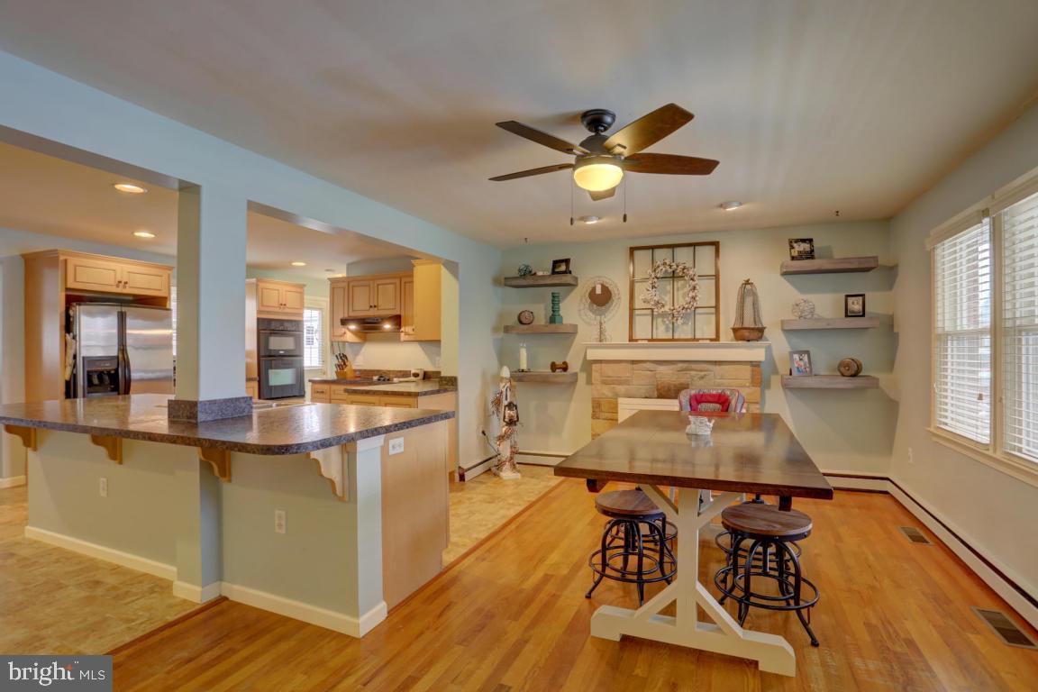 249 East Oregon Road Lititz, PA 17543 - Photo 7 of 30 a kitchen with a dining table chairs and refrigerator