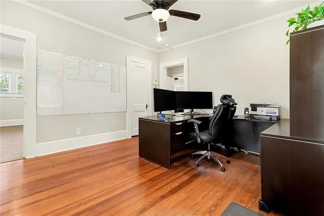 a view of a workspace with furniture and a window