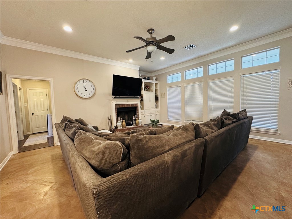 115 Oak Ridge Road Gatesville, TX 76528 - Photo 4 of 37 a living room with furniture a fireplace and a flat screen tv