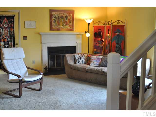 Colorful living room, brightened by a generous window to the side yard and french doors to the patio.