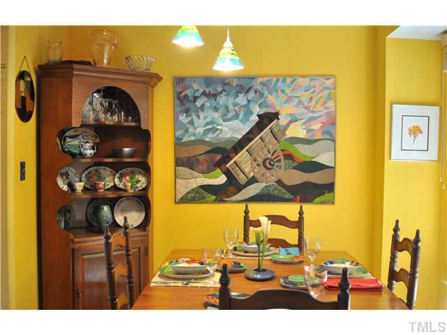 The cheerful dining room is lit by windows looking out to the private patio.