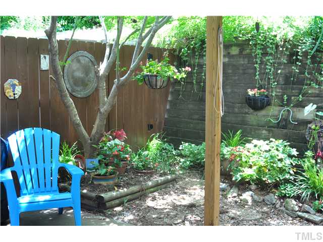Fenced patio offers room for gardening and relaxing in peaceful privacy.