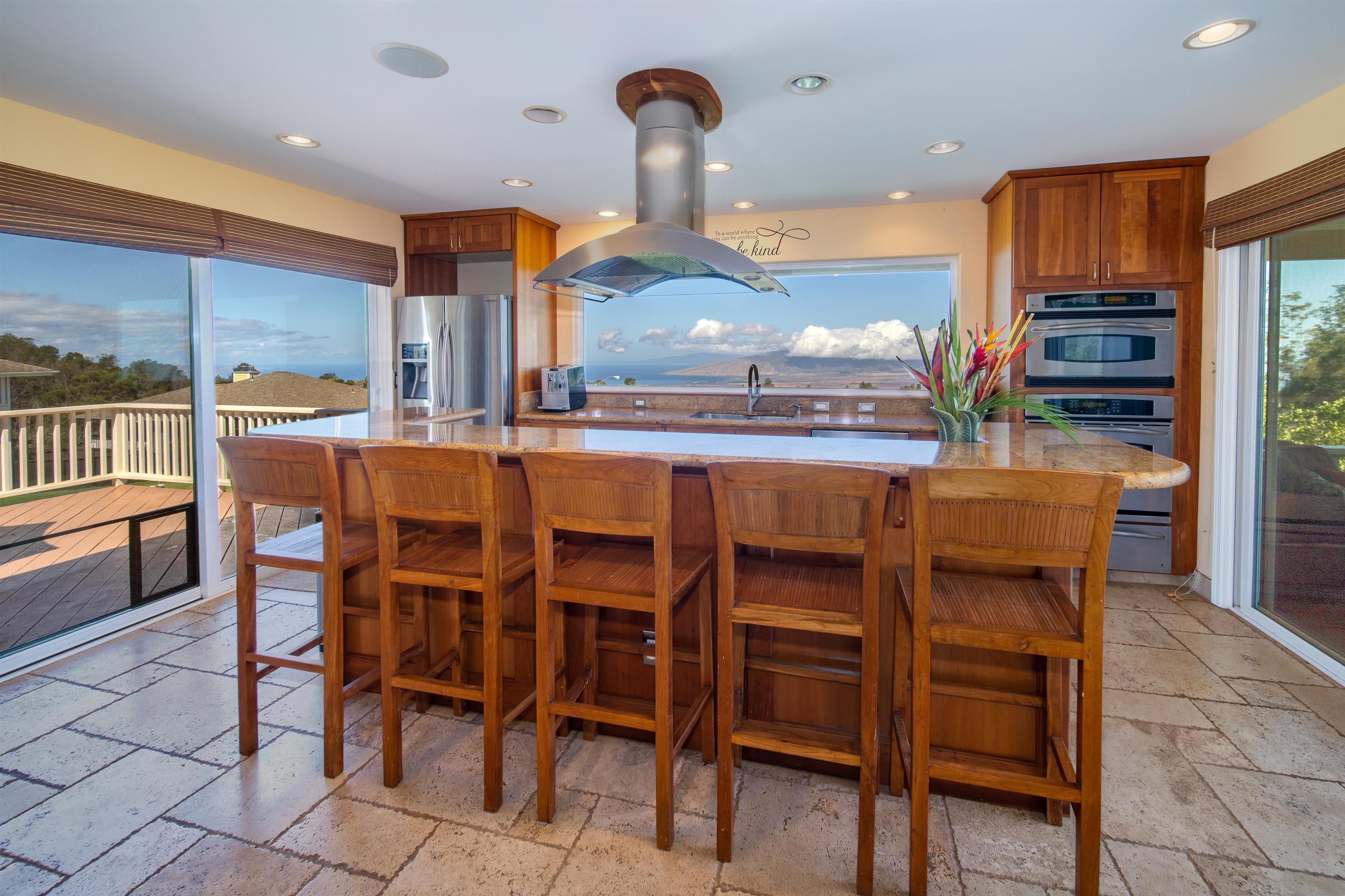 240 Kulamanu Circle Kula, HI 96790 - Photo 5 of 30 a kitchen with stainless steel appliances kitchen island granite countertop a table and chairs in it