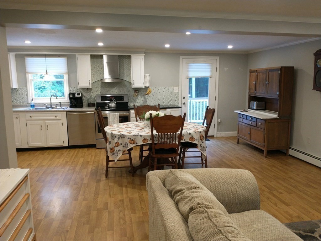 46 Apple Road Brimfield, MA 01010 - Photo 14 of 37 a living room with furniture a dining table wooden floor and a large window