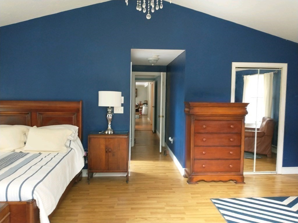 46 Apple Road Brimfield, MA 01010 - Photo 7 of 37 a bedroom with a bed and wooden floor