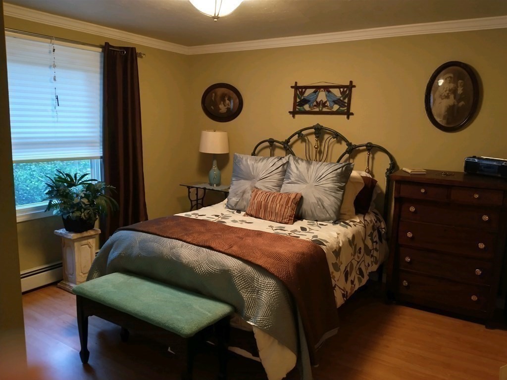 46 Apple Road Brimfield, MA 01010 - Photo 8 of 37 a bedroom with a bed and a chair