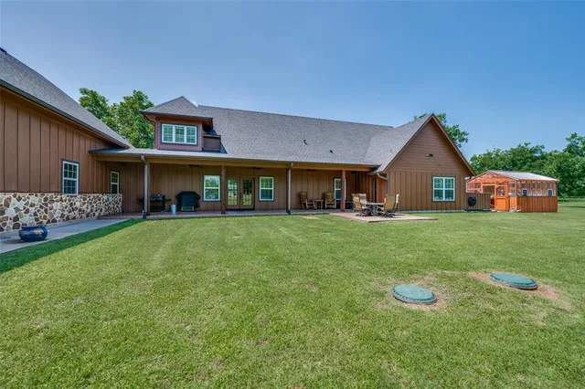 a front view of a house with a yard and trees