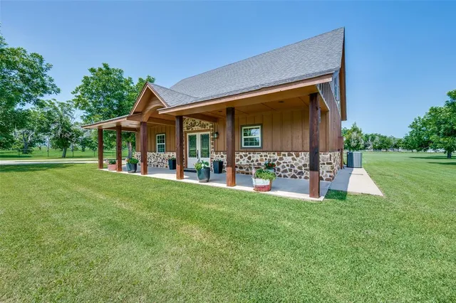 a view of a house with backyard porch and sitting area