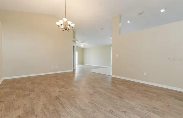 a view of a chandelier in big room and chandelier