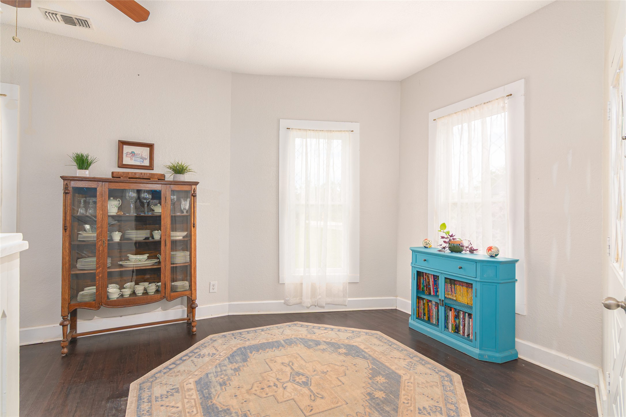 204 Prim Rose Road Blanco, TX 78606 - Photo 15 of 40 Polished hardwood floors and generous sash windows anchor this versatile, light-filled interior space.