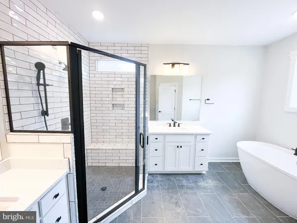 a bathroom with a double vanity sink toilet and shower