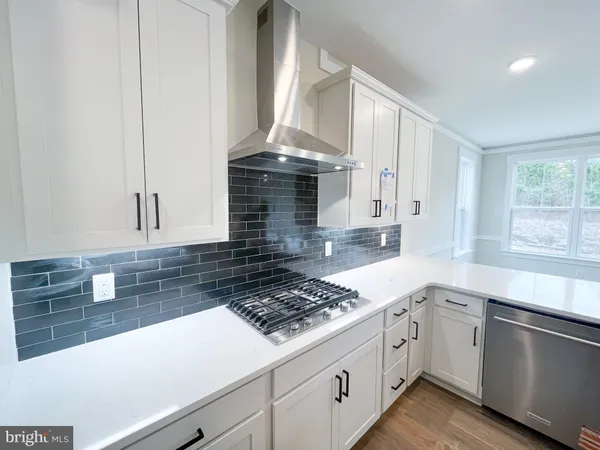 a kitchen with a stove a sink and a microwave